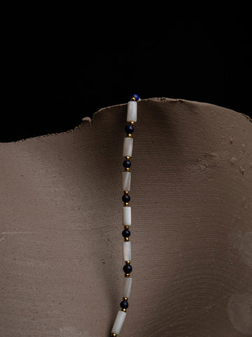 Beaded Necklace with long white beads and small blue lapis beads